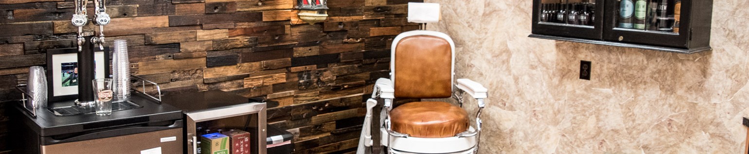 Men's corner of Harpo's Hair Salon with old-fashioned barber's chair, mini refrigerator, alcoholic beverages